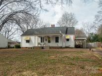 Charming single-story home with white siding, covered porch, and mature trees in a quiet neighborhood at 412 Miles Rd, Shelby, NC 28150