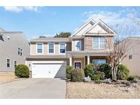 Charming two-story home with a well-manicured lawn and attached two-car garage at 4462 Haddington Dr, Fort Mill, SC 29707