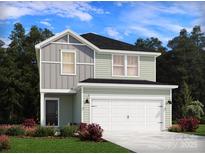 Two-story home featuring light green and gray siding and a two-car garage at 5208 Georgette Trl, Cherryville, NC 28021