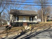 Charming one story home featuring a brick staircase, black shutters and a lovely front yard at 622 Watts St, Albemarle, NC 28001