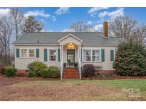 Charming single-story home with a cozy front porch, green shutters, and brick accents at 8639 S Nc Hwy 205 Hwy, Oakboro, NC 28129