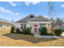 Charming home showcasing a red front door, well-kept lawn, and inviting curb appeal at 9910 Psalms St, Cornelius, NC 28031