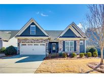 Charming one-story home with stone accents, a two-car garage, manicured lawn, and well-maintained landscaping at 1024 Mayapple Way, Belmont, NC 28012