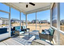 Comfortable screened-in patio with seating area, overlooking a spacious, well-maintained backyard and blue sky at 1024 Mayapple Way, Belmont, NC 28012
