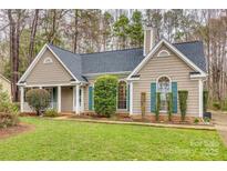 Charming single-story home boasts a well-manicured lawn and inviting curb appeal with lush landscaping at 106 Aurora Ln # 31, Huntersville, NC 28078