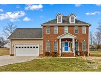 Charming brick home with a two-car garage and a welcoming blue front door at 109 Putney Ct, Salisbury, NC 28147