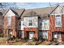 Townhome exterior with brick facade, multiple windows, and well-maintained landscaping at 1127 Central Park Cir, Davidson, NC 28036