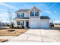 Charming two-story home with a three-car garage and manicured front lawn at 140 Jana Dr, Statesville, NC 28677