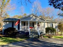Charming ranch-style home with a welcoming front porch and well-maintained landscaping under a clear blue sky at 2321 Lakeview Cir, Matthews, NC 28105