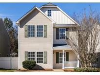 Charming two-story home with light beige siding, green shutters, and a welcoming front porch at 259 Makayla Ct, Fort Mill, SC 29715