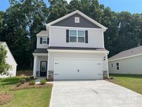 Charming two-story home featuring a two-car garage and traditional design with manicured landscaping at 3267 Maple Ridge Dr, Gastonia, NC 28052