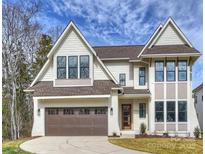 Charming two-story home with a brown roof, a two-car garage and manicured lawn at 5026 Ohm Ln, Charlotte, NC 28270