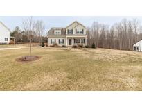 Charming two-story home featuring a welcoming front porch and a well-maintained yard on a spacious lot at 5051 Oxbow Run Ln, York, SC 29710