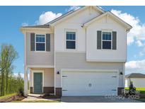 Charming two-story home featuring a white garage door, teal front door, and complementary window shutters at 5207 Georgette Trl, Cherryville, NC 28021