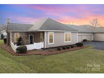 Charming home exterior with manicured lawn, brick accents, and a welcoming front entrance at 8107 Sultana Cir, Charlotte, NC 28227