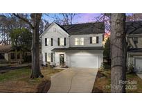 Charming two-story home featuring a two-car garage and a well-manicured front yard in a quiet neighborhood at 1016 Helms Rd, Charlotte, NC 28214