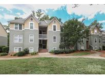 Well maintained condo building with mature trees and inviting landscaping at 20115 Henderson Rd # D, Cornelius, NC 28031