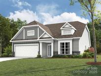 Charming home featuring gray and white siding, a manicured lawn, and a two-car garage, creating a welcoming curb appeal at 2210 Camber Dr # Cwo0075, Gastonia, NC 28054