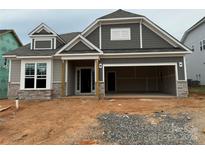 New construction exterior with gray siding, stone accents, and attached two-car garage at 2210 Camber Dr # Cwo0075, Gastonia, NC 28054