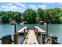 Inviting lake view from private boat dock, ready for summer fun and relaxation on the water at 353 Whippoorwill Rd, Mooresville, NC 28117