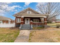 Charming brick home with a welcoming front porch and gray stairs leading to the front door at 3530 Statesville Blvd, Salisbury, NC 28147