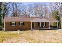 Charming one-story brick home with a covered front porch and well-maintained yard at 3617 12Th Street Ne Dr, Hickory, NC 28601