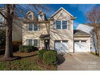 Charming two-story home with dormer windows, two-car garage, and well-maintained landscaping in a residential neighborhood at 117 Richland Ln, Mooresville, NC 28115