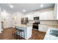 Modern kitchen with stainless steel appliances, granite countertops and island with seating at 121 Edgehill Ct, Troutman, NC 28166