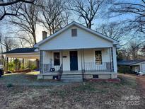 Charming single-story home featuring a covered porch and a well-maintained front yard at 1216 Innis Ave, Kannapolis, NC 28081