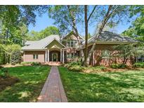 Charming brick home with a welcoming front porch and beautifully landscaped yard at 12702 Overlook Mountain Dr, Charlotte, NC 28216
