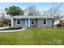 Charming single story house with a well maintained lawn and a light blue front door at 4501 Knollcrest Dr, Charlotte, NC 28208