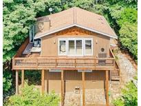 Charming cabin featuring a cozy deck, wood siding, and a scenic, wooded backdrop at 9009 Cebu Ct, Fort Mill, SC 29708