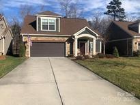 Charming home with a stone facade, covered entryway, two-car garage, and well-maintained landscaping at 1220 Avalon Pl, Matthews, NC 28104