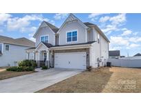 Charming two-story home featuring a two-car garage and stone accents, complemented by a well-maintained lawn at 2174 Black Forest Cv, Concord, NC 28027
