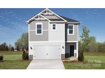 Inviting two-story home featuring a two-car garage, neutral color palette, and lush landscaping at 459 Olympia Way, York, SC 29745