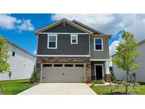 Charming two-story home featuring a two-car garage, stone accents, and well-maintained landscaping in the front yard at 459 Olympia Way, York, SC 29745