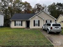 Charming home featuring a well-maintained lawn and a private driveway at 5702 Burning Ridge Dr, Monroe, NC 28110