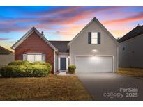 Charming two-story home with a brick and vinyl exterior and well-maintained landscaping at 5720 Parkstone Dr, Matthews, NC 28104