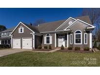 Charming single Gathering house featuring a two-car garage, manicured lawn, and inviting curb appeal at 8413 Albury Walk Ln, Charlotte, NC 28277