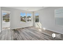 Bright bedroom featuring hard surface flooring, large windows that provide natural light, and neutral paint at 1211 Pine St # A, Mooresville, NC 28115