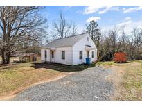 Charming one-story home with gravel driveway and small, vintage storage building at 2539 4Th Sw Ave, Hickory, NC 28602