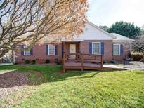 Charming brick home features mature trees, a well-maintained lawn, and a convenient front entry ramp at 2623 Shaw Ave, Gastonia, NC 28054