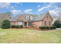 Well-maintained brick home with manicured lawn and shrubbery at 5125 Belicourt Dr, Charlotte, NC 28277