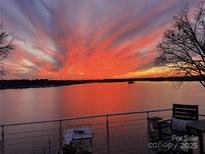 Breathtaking sunset view from the balcony overlooking the tranquil waterfront at 7111 Anchorage Ln, Tega Cay, SC 29708