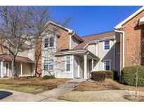 Charming townhouse with a brick and vinyl exterior and well-maintained front yard at 7804 Renaissance Ct # A, Charlotte, NC 28226