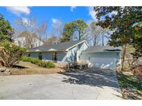 Charming single-Gathering home featuring light blue siding, stone accents, and an attached two-car garage at 1205 Molokai Dr, Tega Cay, SC 29708