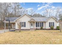 Charming single-story home with a well-maintained lawn and inviting curb appeal at 124 Woodside Ln, Lancaster, SC 29720