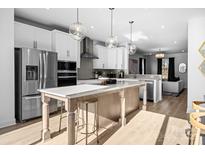 Bright, modern kitchen with a large island, stainless steel appliances, and pendant lighting at 14024 Felix Ln # 4, Charlotte, NC 28277