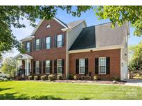Beautiful two-story brick home with black shutters and a well-manicured lawn at 150 Harbor Cove Ln, Mooresville, NC 28117