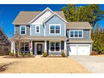 Charming two-story home with a two-car garage, covered front porch, and manicured lawn at 160 Sweet Briar Dr, Fort Mill, SC 29707